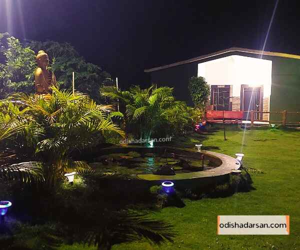 evening-time-in-rabandhara-nature-camp-park-view-of-room-front-lighting-and-Buddha-idol-in-the-park