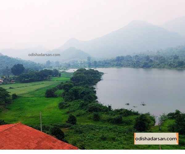 view-of-rabandhara-nature-camp-from-the-top-floor-sourrounded-by-green-trees-and-moutains